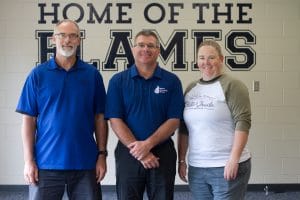 Kendal Bauman (left) and Jennifer Young (right), "roasted" Dave Bechler, center, at a spring recognition dinner where Bechler was recognized for 23 years of service to EMS as athletic director.