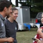 Andrew Gascho and crosss country coach, Katie Cimini, visit with Mrs. Burtner of the Burtner Farm cross country course in Penn Laird.