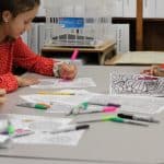 Students quietly color and listen to music during Spiritual Renewal Week Sabbath practices