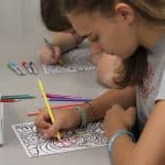 Students quietly color and listen to music during Spiritual Renewal Week Sabbath practices
