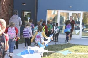 Students taking supplies to the new building.