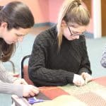 Claudia Fencer, AP bio teacher, works with a student.