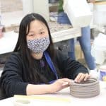 International student (South Korea) in ceramics class