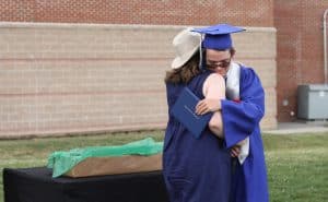 Erin Kennedy Hess, advancement assistant, greets her son, Eli, commencemnt 2021
