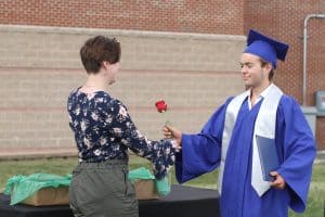 Leah Huyard, 6th grade teacher, greets her brother Luke, commencemnt 2021