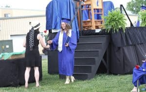 Emma Myers receives a rose from Jodi Hertlzer, class sponsor, commencement 2021