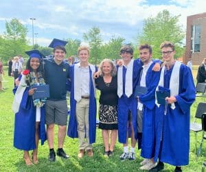 Maria Archer (center), K-8 principal, with '21 graduates who attended EMES