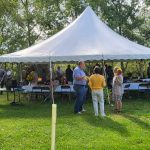 Class of '81 gathered under a tent at the farm of Eric and Luann Bender