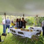 Class of '81 gathered under a tent at the farm of Eric and Luann Bender