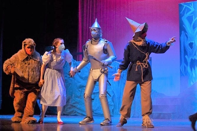 Eli Stoll '22, Clair Parsley '22, Silas Sawatzky '22, and Ben Huyard '23, follow the yellow brick road during the 2022 musical, "The Wizard of Oz." Photo by Joaquin Sosa
