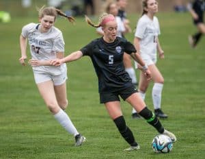 Eastern Mennonite's Sarah Drooger drives up the field past Chatham Hall's Allie Midkiff.